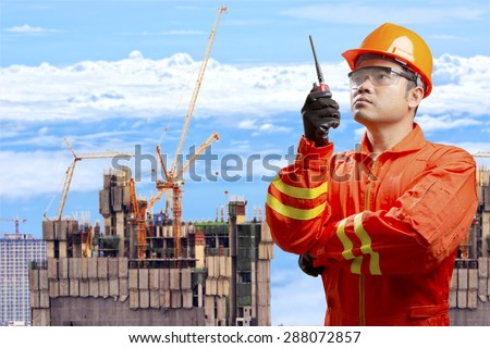 Engineer use radio communication control working at high building construction site
