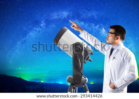 Astronomer pointing at milky way and space telescope of observatory. elements of this image furnished by NASA.