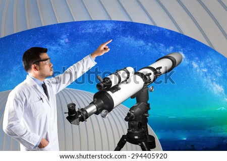 Astronomer pointing at milky way and space with telescope of observatory dome watching. elements of this image furnished by NASA.