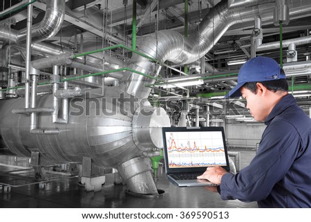 Technician use computer check for maintenance equipment and pipeline in a modern thermal power plant industrial