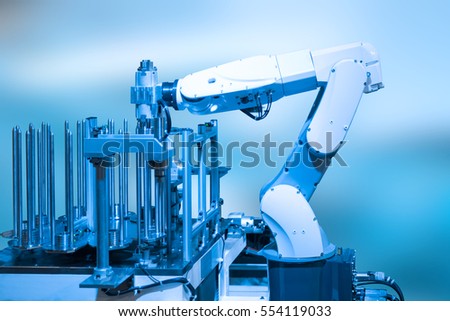 Industry concept and blue tone of automated robot arm in production line of smart factory