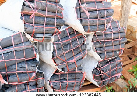 Charcoal bags stacked in preparation for sale.