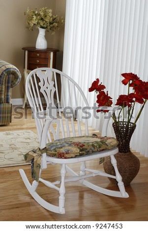 Rocking chair and flowers in a wicker basket