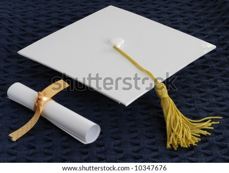 White graduation cap and diploma.