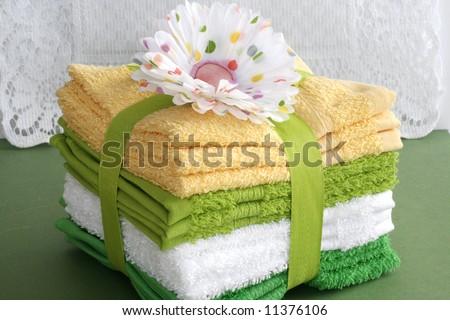 Terry cloth towels wrapped with ribbon and flowers