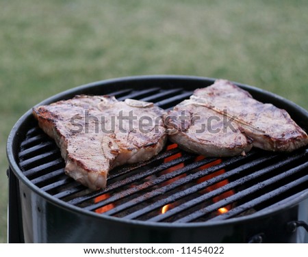 Cooked beef on barbecue with fire