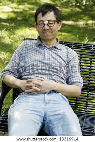 Man with glasses on park bench