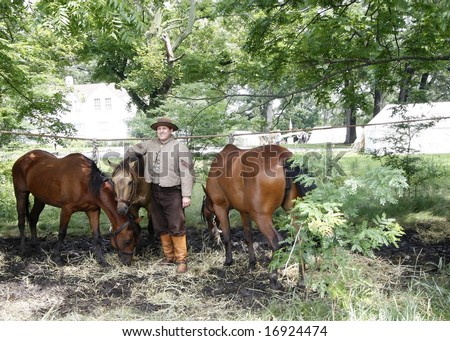 Civil war actor standing by his horses