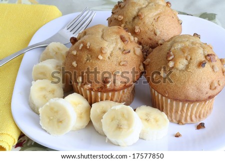 Three banana nut muffins served with bananas