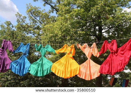Bright colored dresses hanging on clothes line