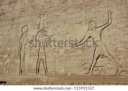 Hieroglyphic carvings on the wall of an ancient egyptian temple