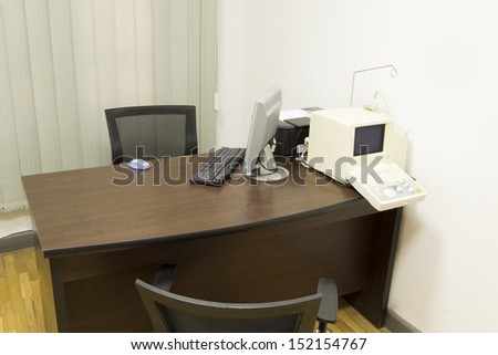 doctors consultation room with computer with ecg machine