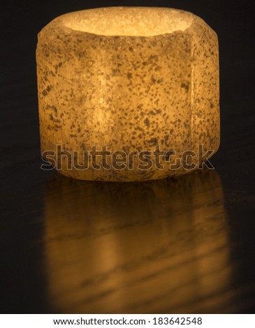 Ornate rock salt tealight candle holder isolated on a black background