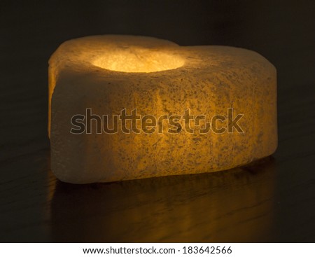 Ornate rock salt tealight candle holder isolated on a black background