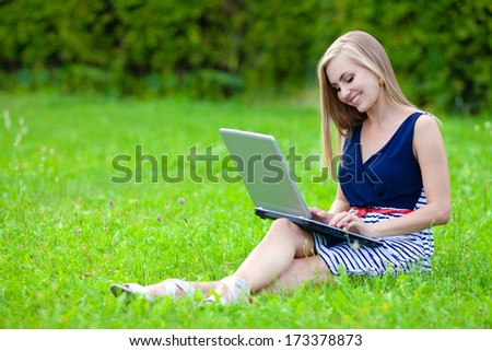 Woman with laptop in the park