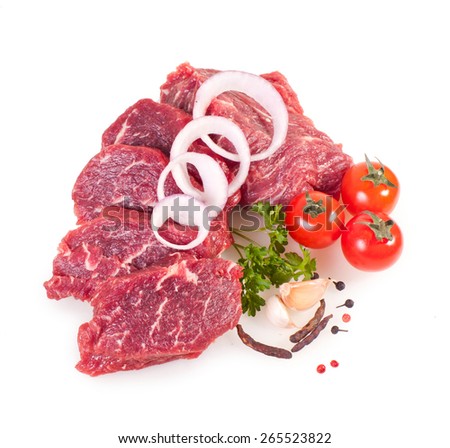 Raw pieces of crude meat with vegetables isolated on white background