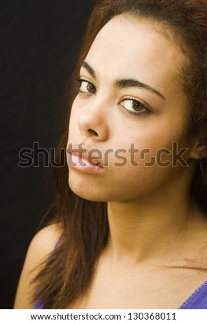 Portrait of an attractive black woman isolated on black background