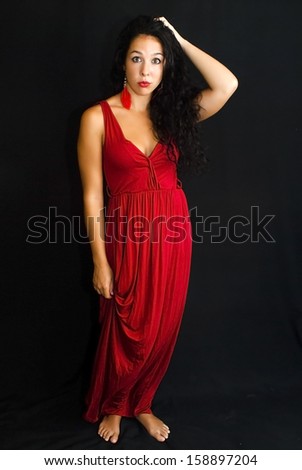 Wonderful latin woman with red dress on black background