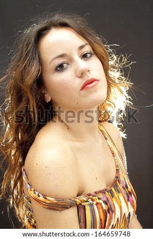 Wonderful woman with colorful dress on black background