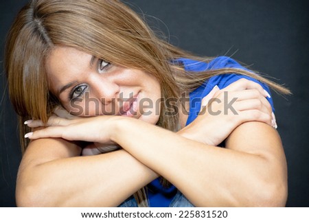 Portrait of Beautiful Young Woman Hugging Herself  Over Black Background