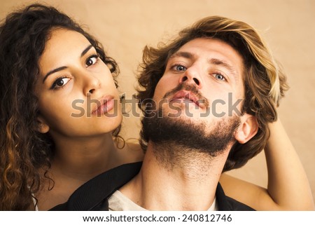 Beautiful portrait of a loving couple. She\'s pulling his hair.