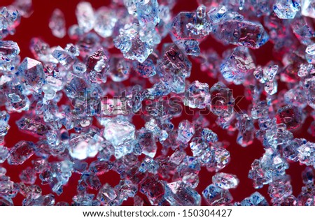 Blue crystals on a red background. Extreme closeup. Macro