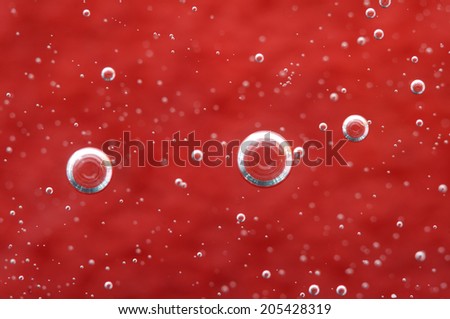 Air bubbles in a liquid. Abstract red background.  rather unique macro photo, for your  successful business design. Macro