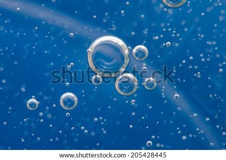 Air bubbles in a liquid. Abstract blue background.  rather unique macro photo, for your  successful business design. Macro