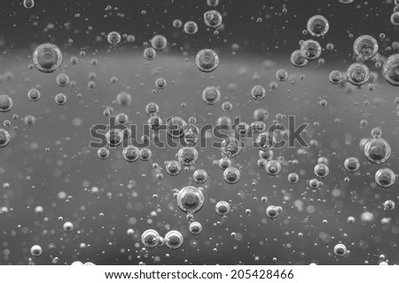 Air bubbles in a liquid. Abstract black-and-white background.  rather unique macro photo, for your  successful business design. Macro