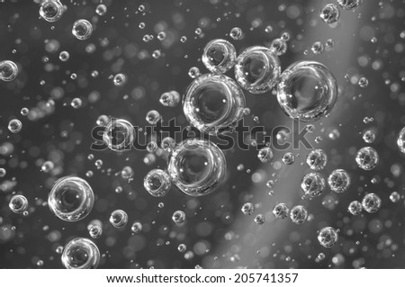 Air bubbles in a liquid. Abstract black-and-white background. Macro