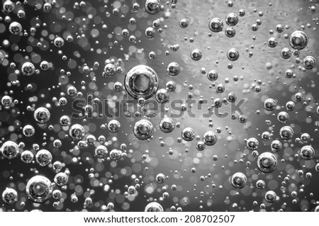 Air bubbles in a liquid. Abstract black-and-white background. rather unique macro photo, for your successful business design. Macro