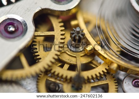 Background with golden metal cogwheels inside clockwork. Conceptual photo for your successful business design. Macro.
