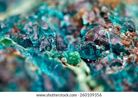 Chrysocolla is a hydrated copper cyclosilicate It has the chemical formula (Cu,Al)2H2Si2O5(OH)4nH2O.Cyan (blue-green) crystal. Macro. Beautiful fantastic background for successful Your projects