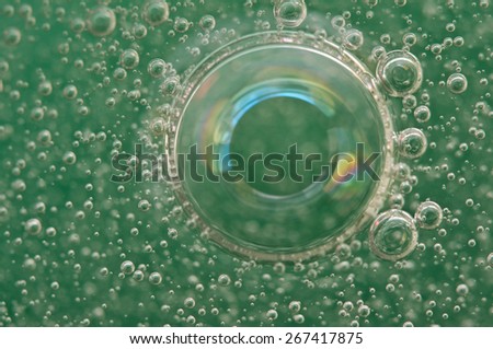 Macro Oxygen bubbles in water on a green background,  concept such as ecology and other your successful projects