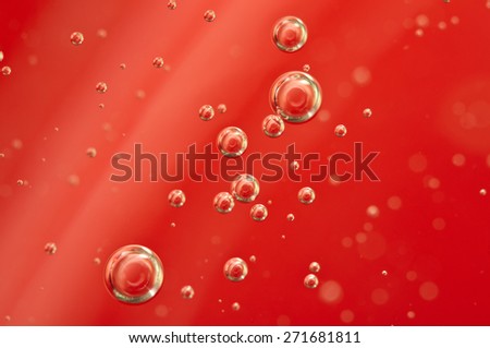 Air bubbles in a red liquid , concept such as medical research of blood and other your successful projects. Macro