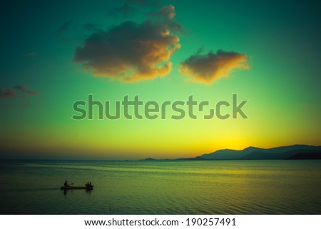 Fishing Boat with fisherman at magic green Sunset on Koh Samui