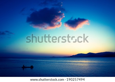 Fishing Boat with fisherman at magic blue Sunset on Koh Samui