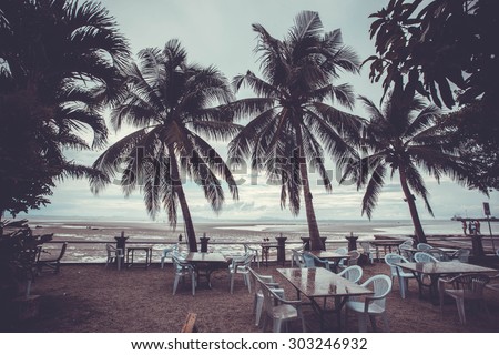 Outside restaurant at the beach in rain time with palms tree. Koh Samui Nathon