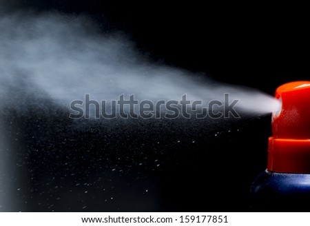spray aerosol on black background