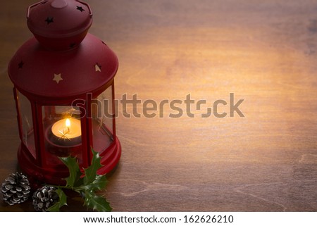christmas candle lamp with decoration on wooden
