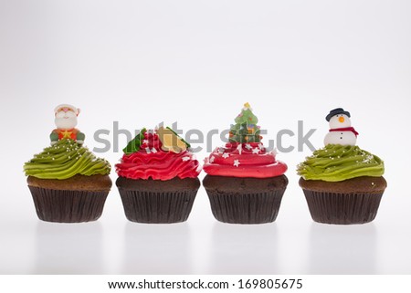 isolated colorful xmas cupcakes on white