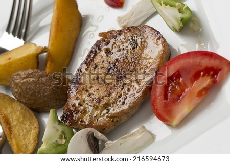 grilled pork chop with steak fries and mixed vegetable
