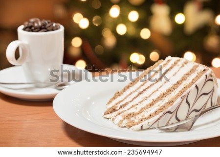 one slice of cake served on the plate, decorated with whipped cream and cafe mug