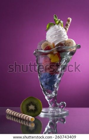 colorful mixed fruit cup with whipped cream decorated