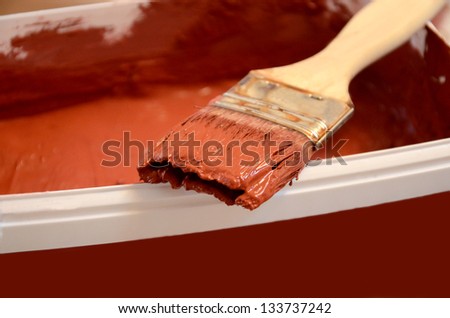 Red terracotta paint tray and brush