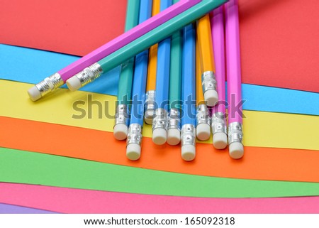 color pencils and sheets of colored paper