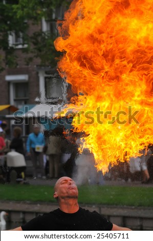 A street entertainer breathing fire in front of a large crowd of people,Schravendeel,Holland