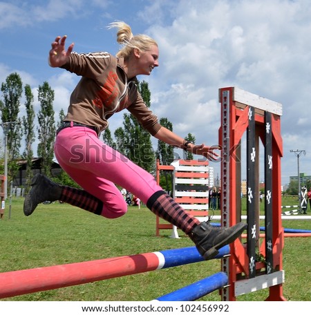 Woman jumping barrier