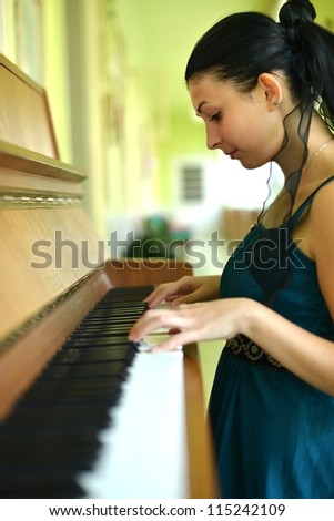 beautiful young woman playing the piano