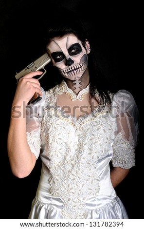 Young woman in day of the dead mask skull face art. Halloween face art.